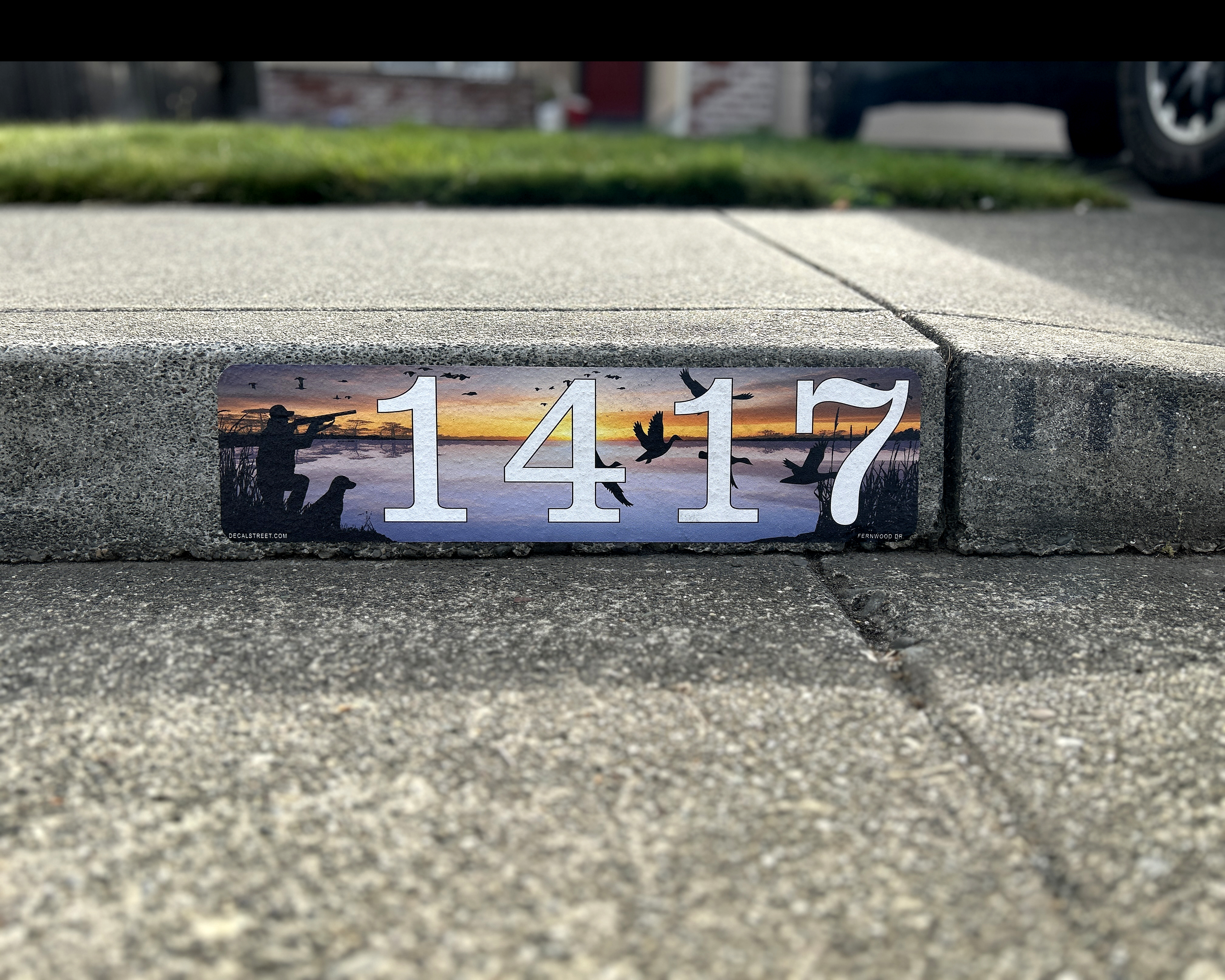 Custom curb address decal installed on concrete curb
